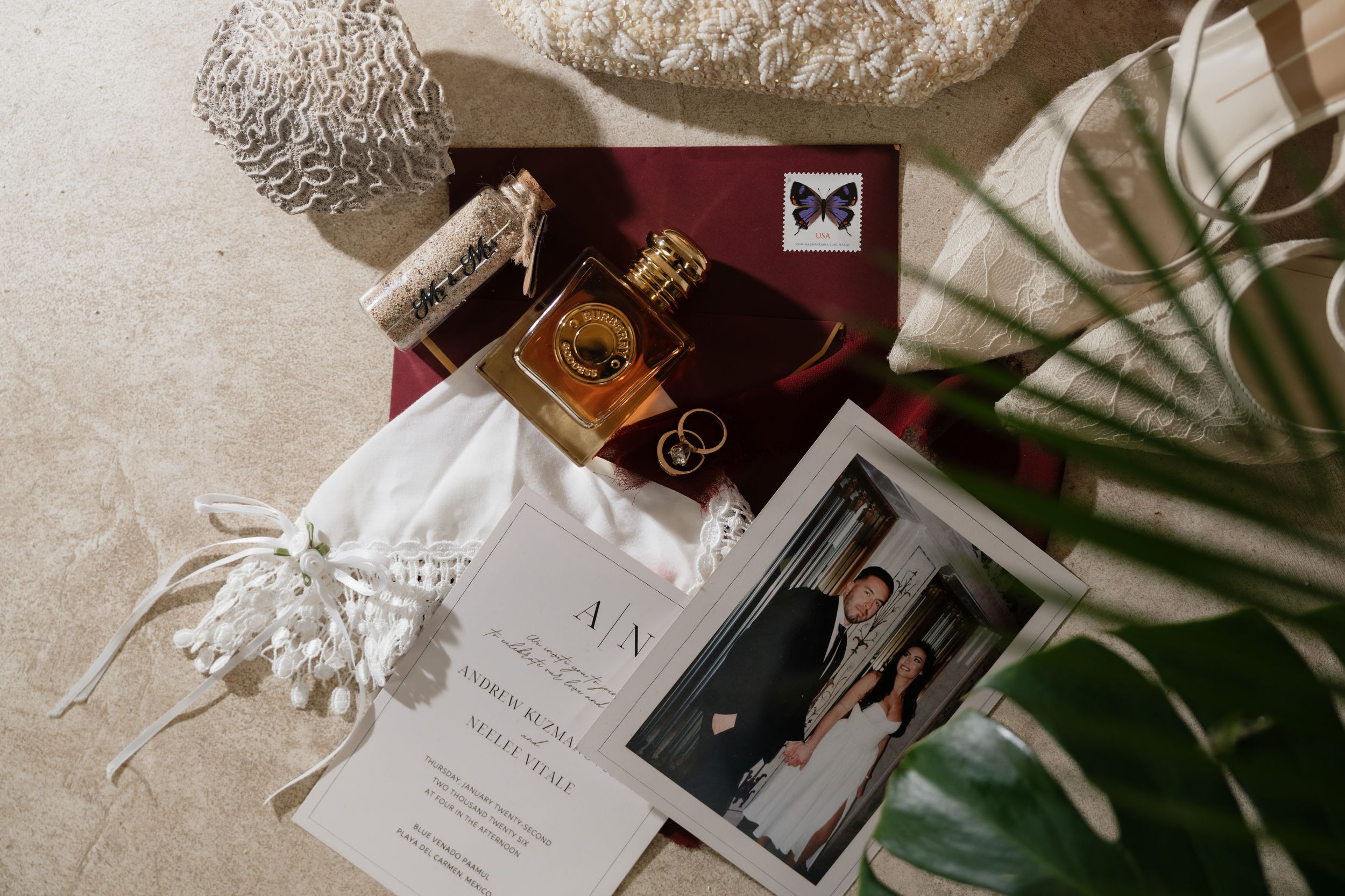 Bridal wedding details including invitations, rings and accessories styled with seashells and natural elements at Blue Venado Paamul