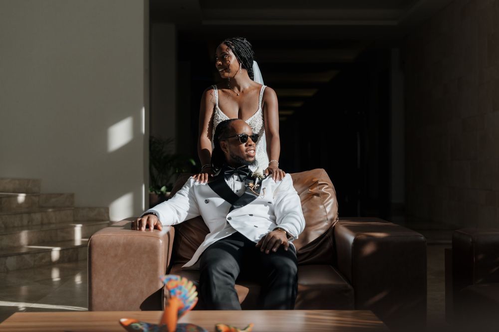 Bride and groom portrait on a couch at Majestic Elegance Costa Mujeres
