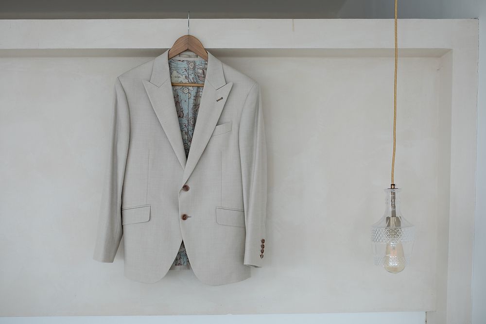 Light gray suit jacket photographed from multiple angles showing details of tailoring and construction.