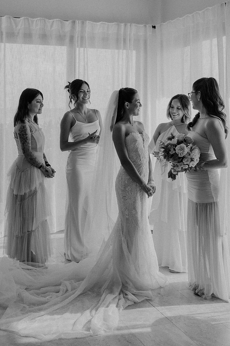 Bride standing with bridesmaids in elegant dresses during preparation for the Blue Venado wedding.