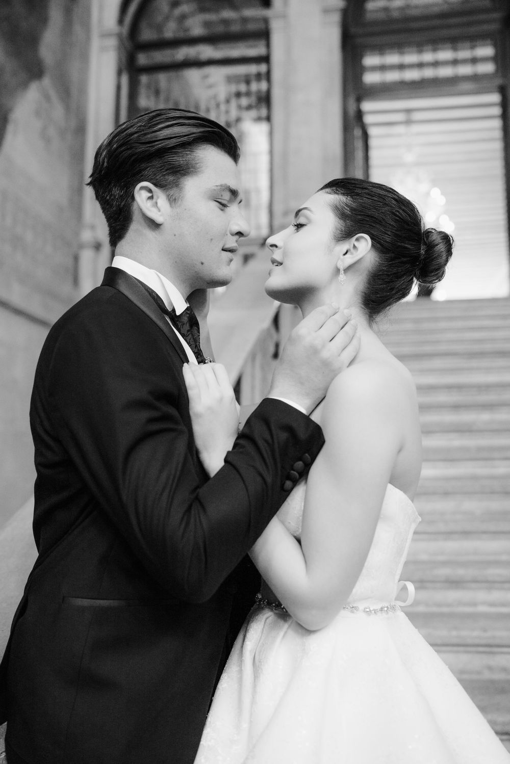 A romantic sequence of black and white wedding photos showing a couple in formal attire sharing intimate kisses.