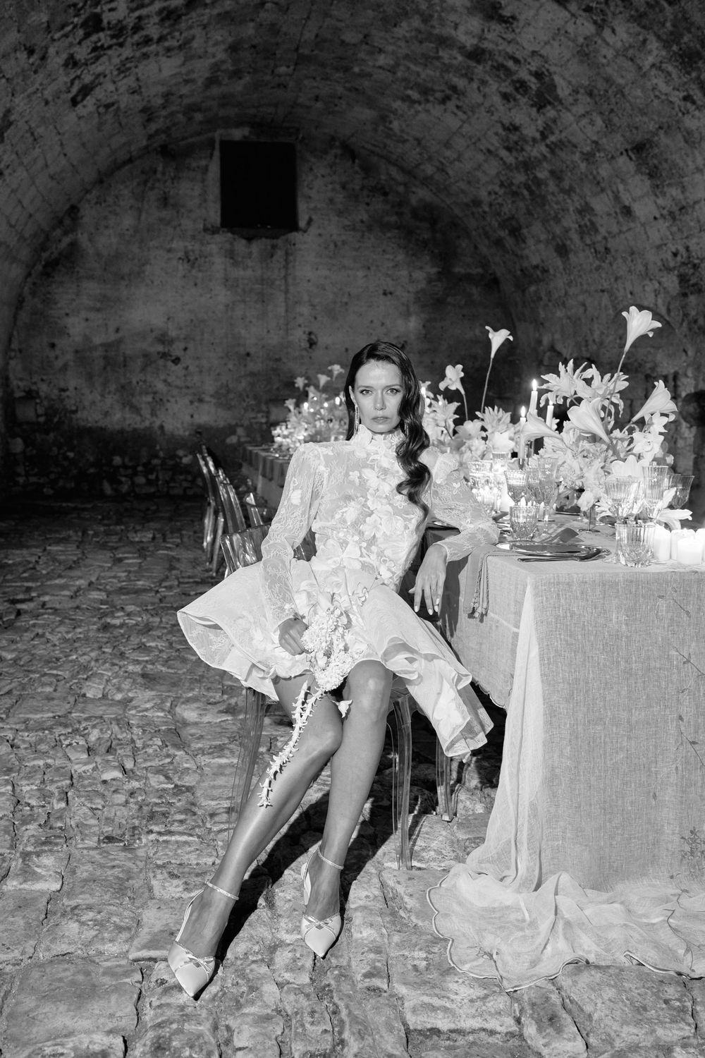 A series of vintage black and white photos showing a formal dining setup in what appears to be a stone cellar or vault.