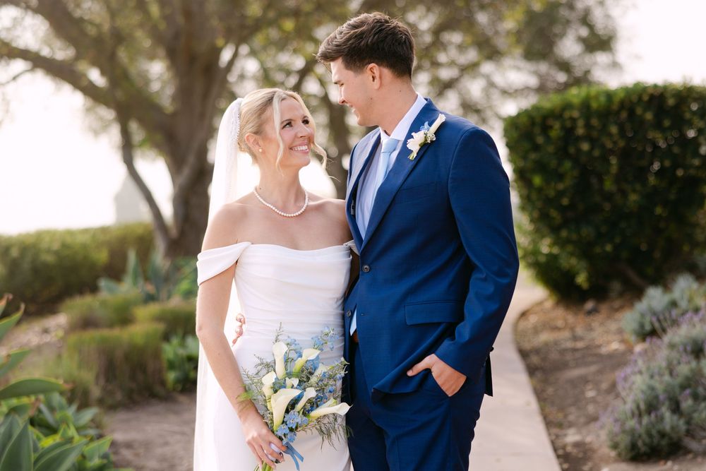 A romantic wedding scene captured in a lush garden setting with soft natural light filtering through.