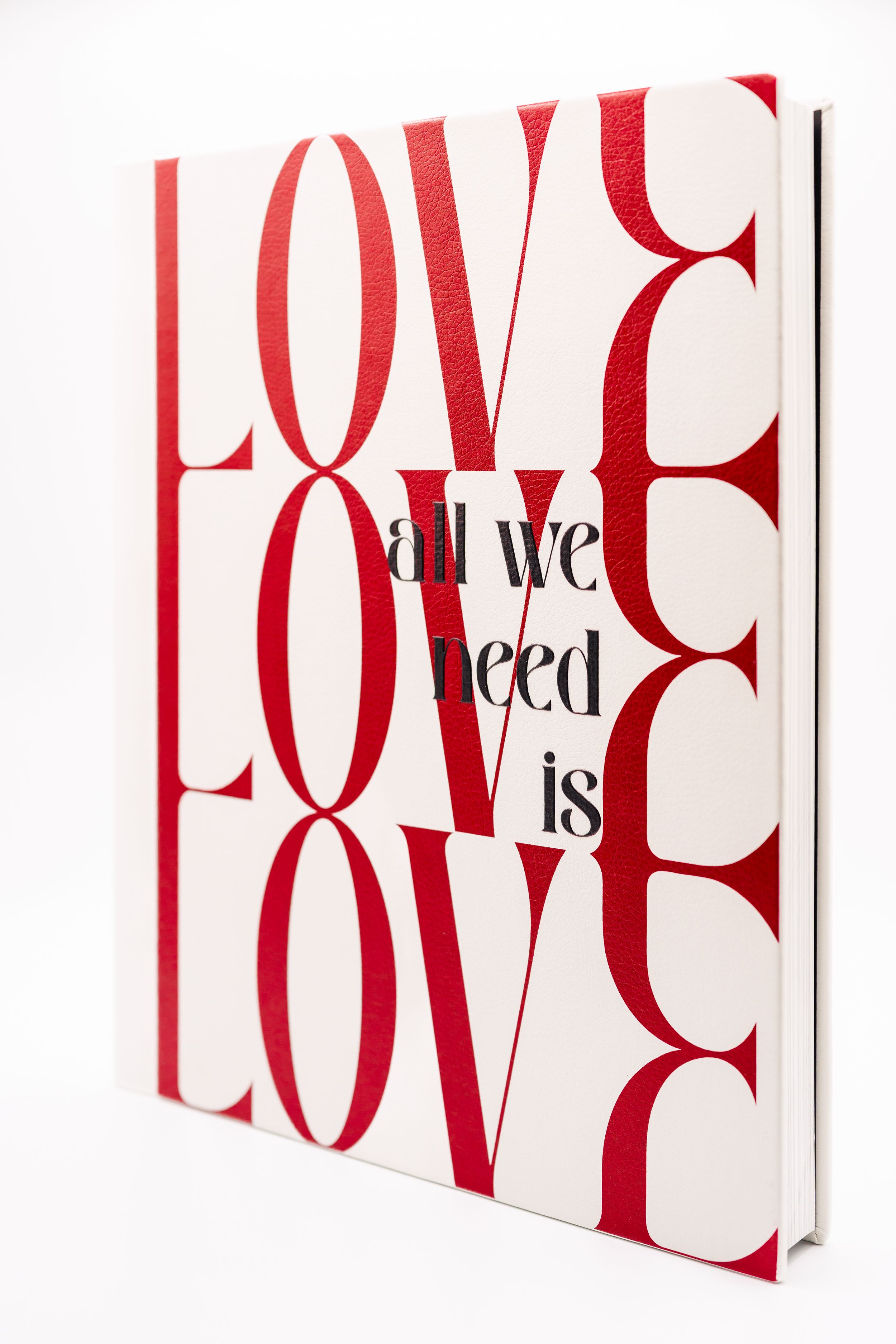 White book covers with red LOVE text displayed in a row showing different angles of the same minimalist design.