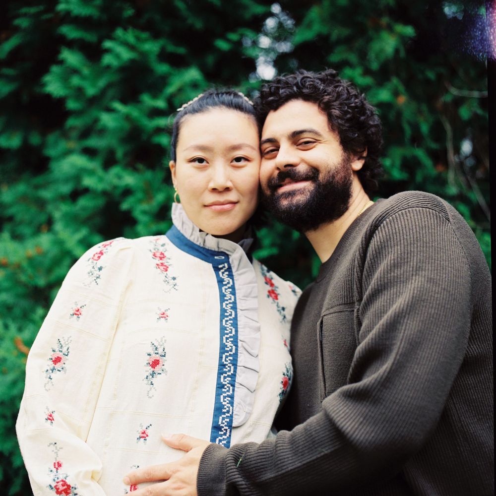 Portrait of couple by the trees during a mini-moon getaway to Kennebunkport, Maine. A 120mm photograph taken during a maternity session.
