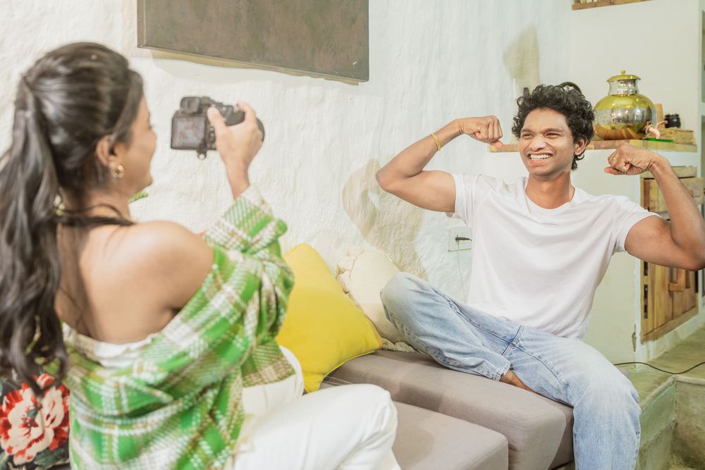 A couple having fun during a casual photoshoot session in their living room.