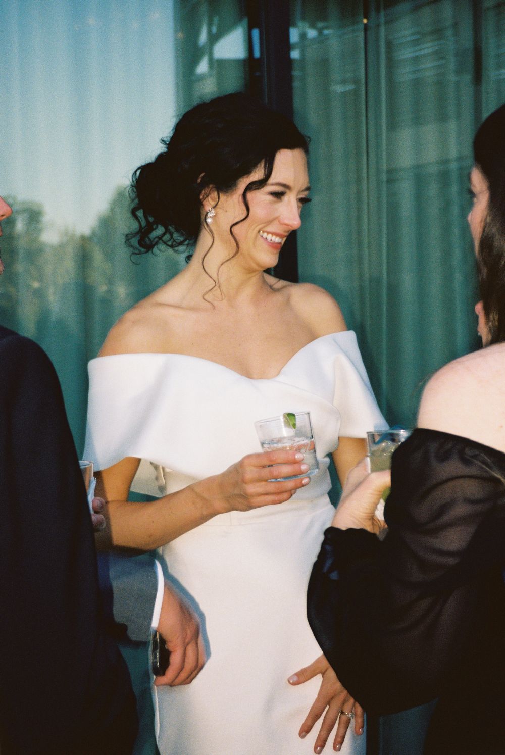 Wedding celebration scene with elegant white dress and cocktail drinks in a modern setting.