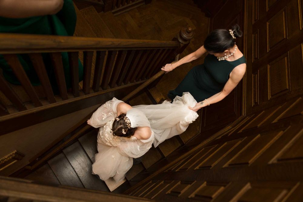 A series of photos showing someone in a white dress descending a wooden staircase with assistance.