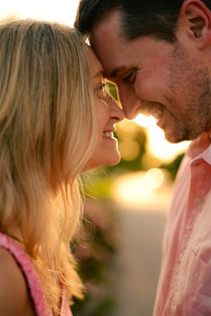 An intimate close-up silhouette of a couple in warm sunset lighting.