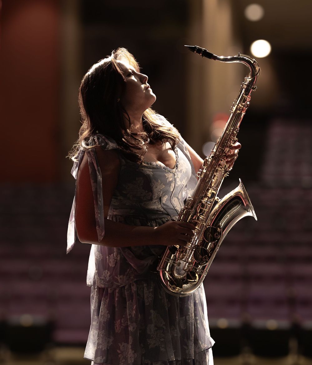 Senior photos in the Blair High School Auditorium, playing her saxophone.