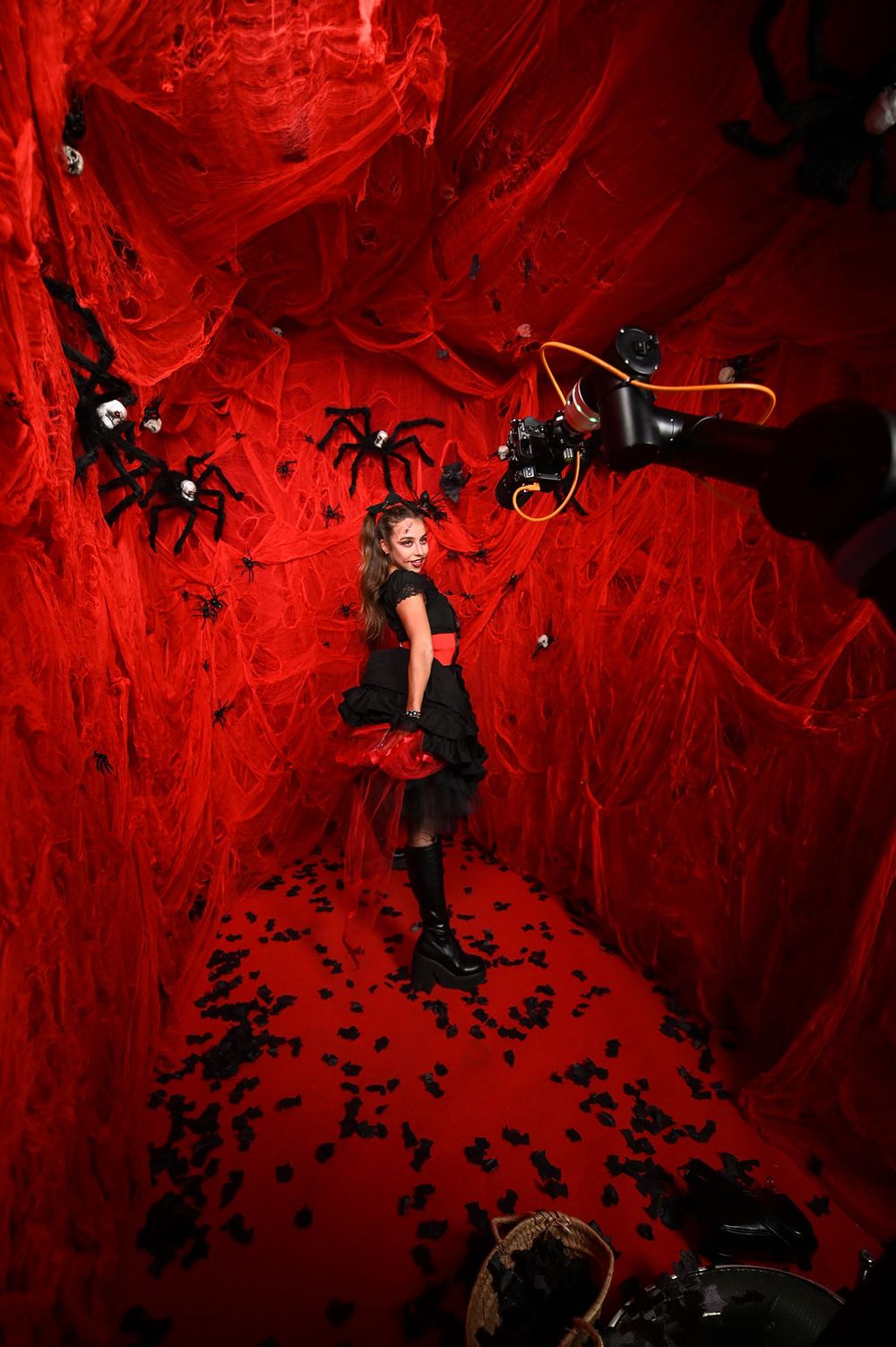 Enola Bedard at our GlamBot with a red Halloween decor with spiders at the YouTube x Lady Gaga Mayhem Halloween Party – La Paloma Barcelona