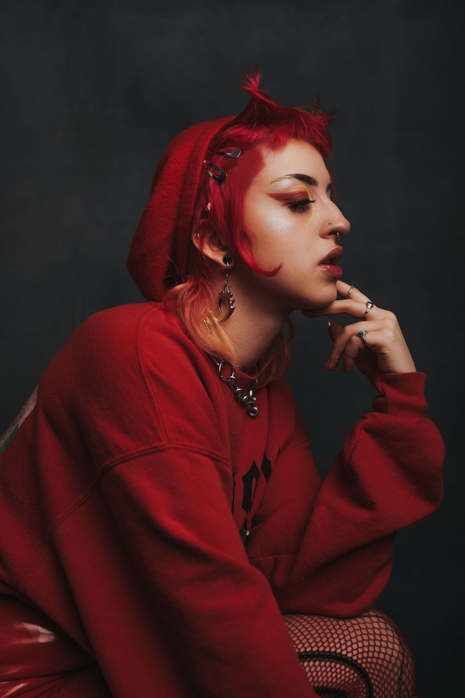 Artistic fashion portrait series in deep red featuring dramatic poses against dark background with gothic styling.