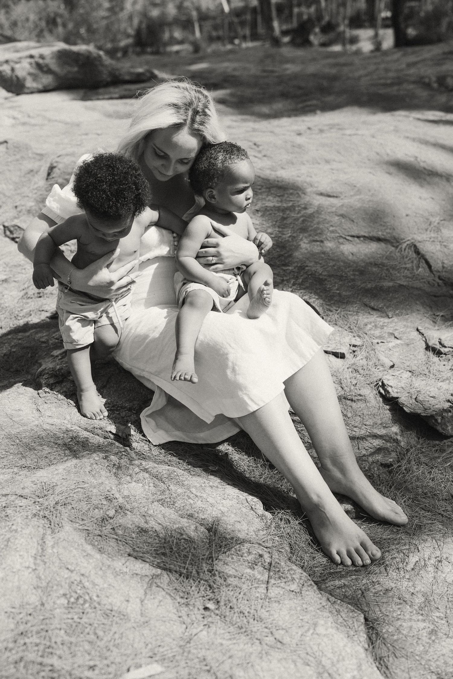 Black and white photo series of people relaxing on natural rock formations.