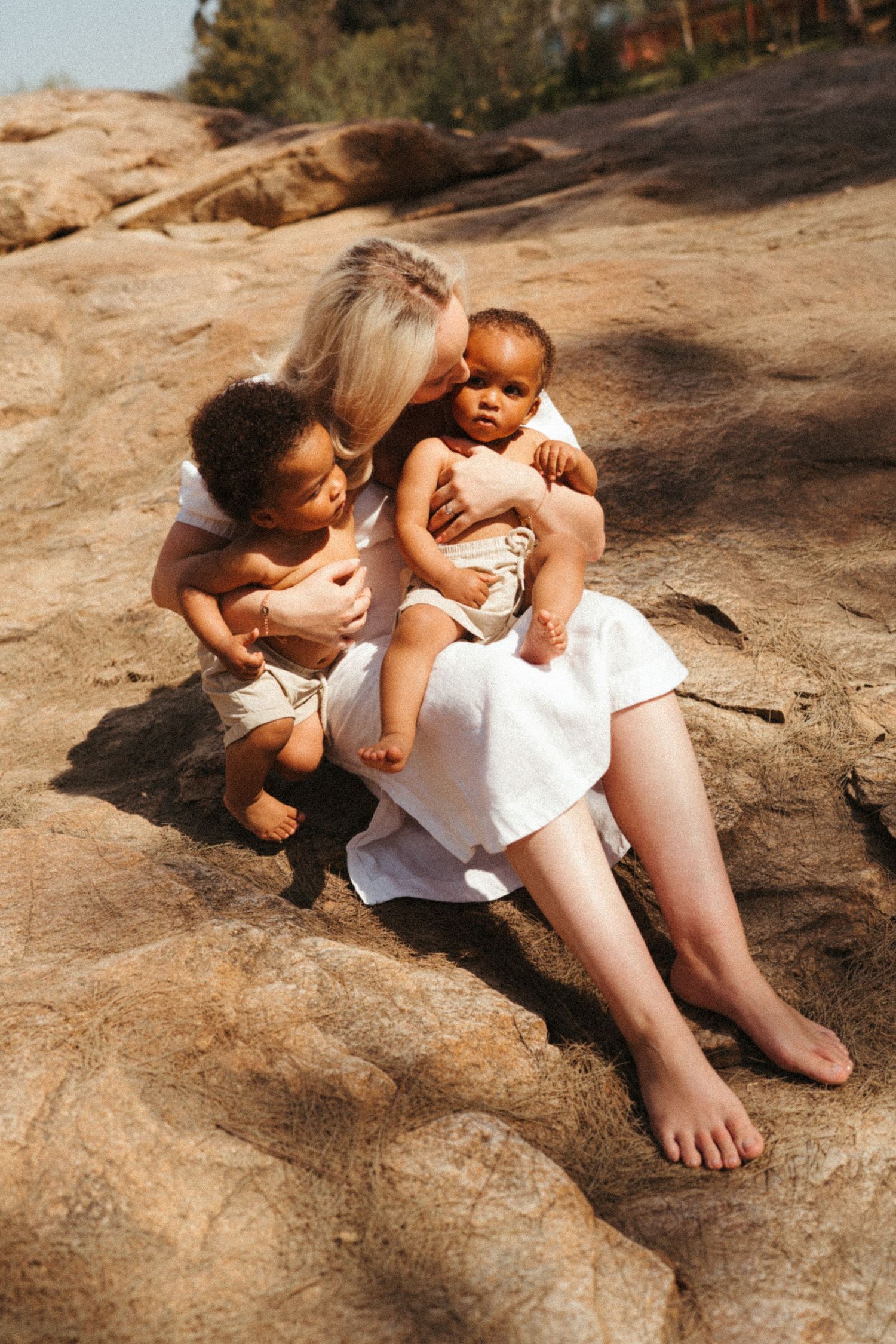 Natural lifestyle photos of people resting on rocky terrain in sunlight.