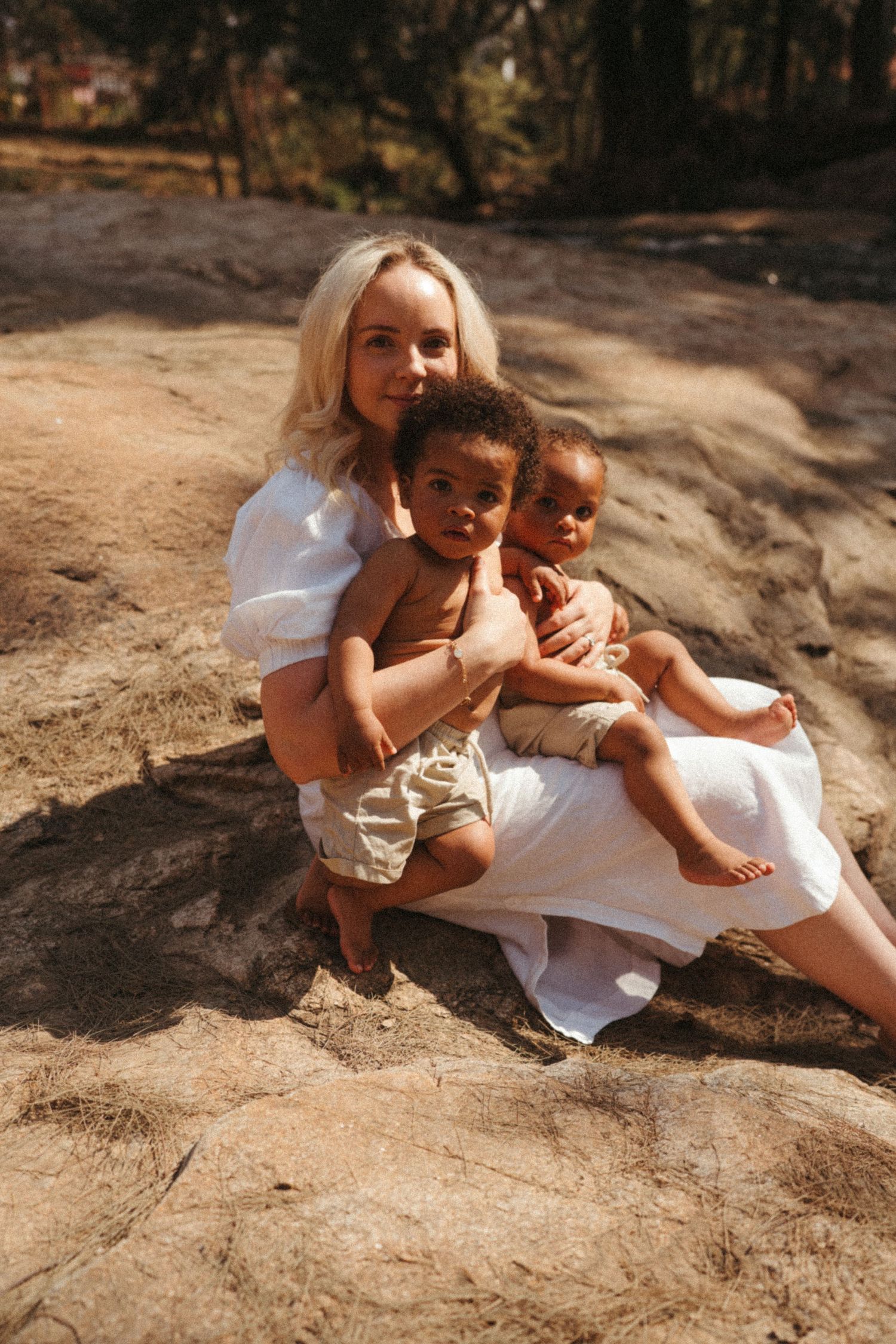 Candid outdoor photography sequence showing loving interactions on rocky terrain in warm sunlight.