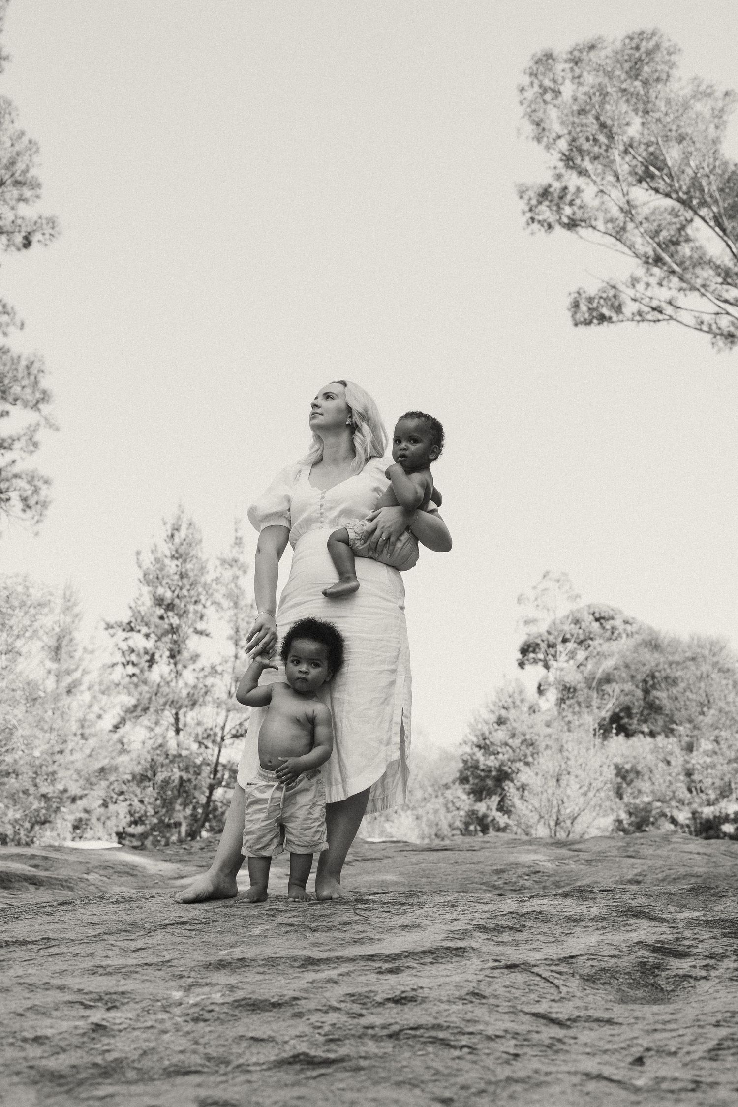 Black and white photography sequence showing movement and interaction on a natural landscape.