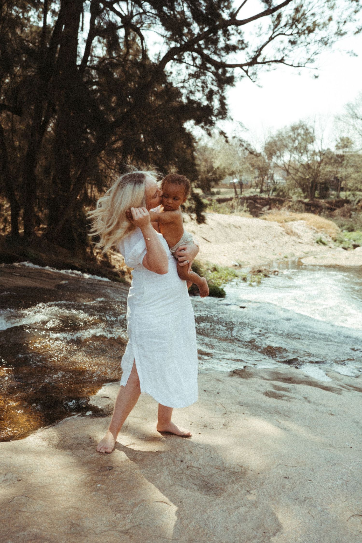 Candid photography sequence showing tender moments between adult and child in nature setting.
