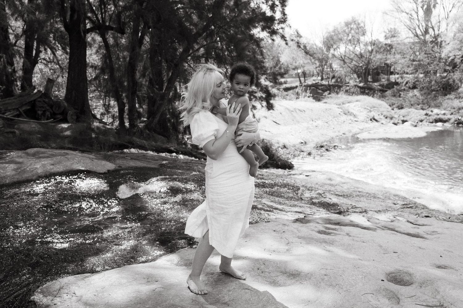 Artistic black and white series capturing movement and connection in outdoor setting.