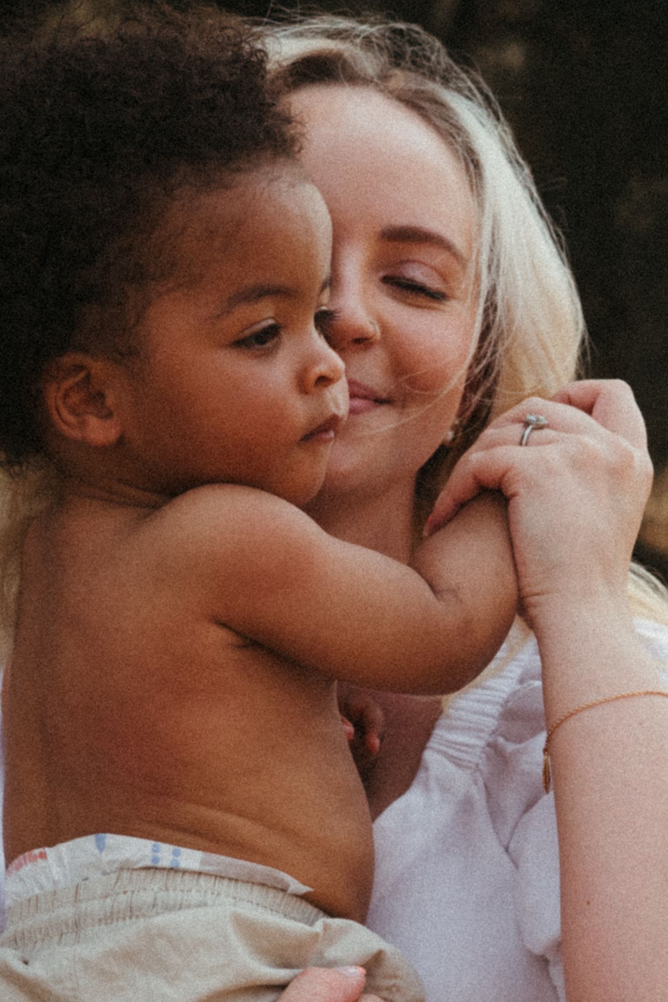 Close-up emotional portrait capturing intimate moment between caregiver and child.