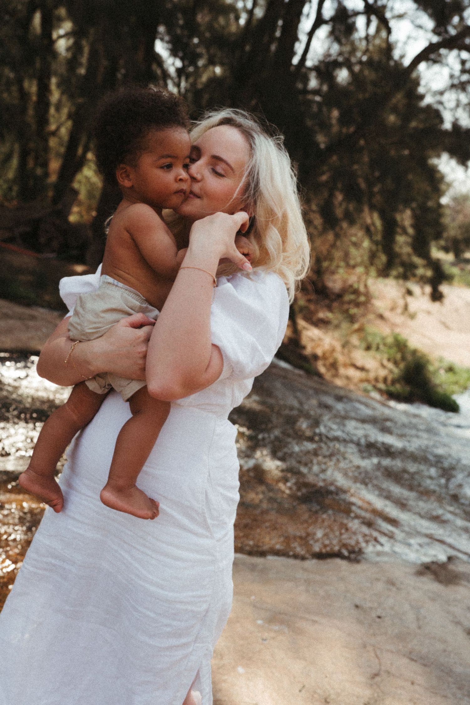 Sun-lit outdoor photography sequence showing tender moments between a mother and child.