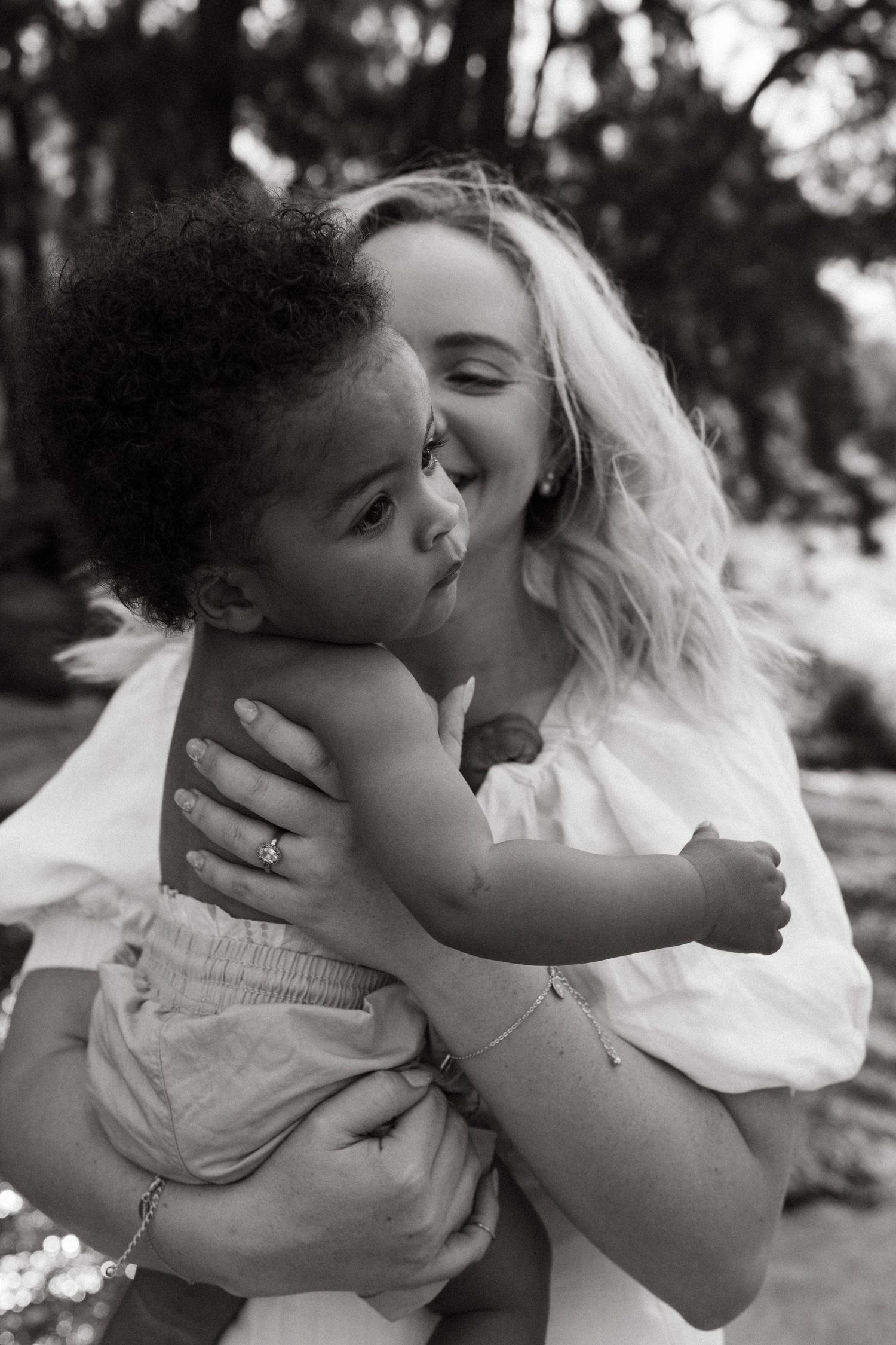 Emotional black and white portraits capturing intimate bonding moments in natural setting.