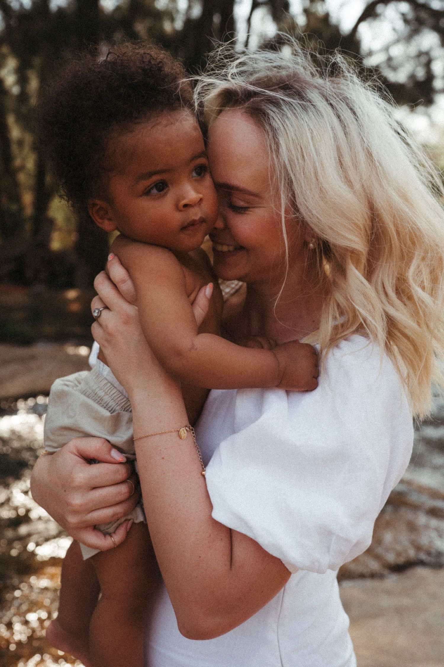 Sweet candid moments of parent and child sharing loving expressions in an outdoor setting.