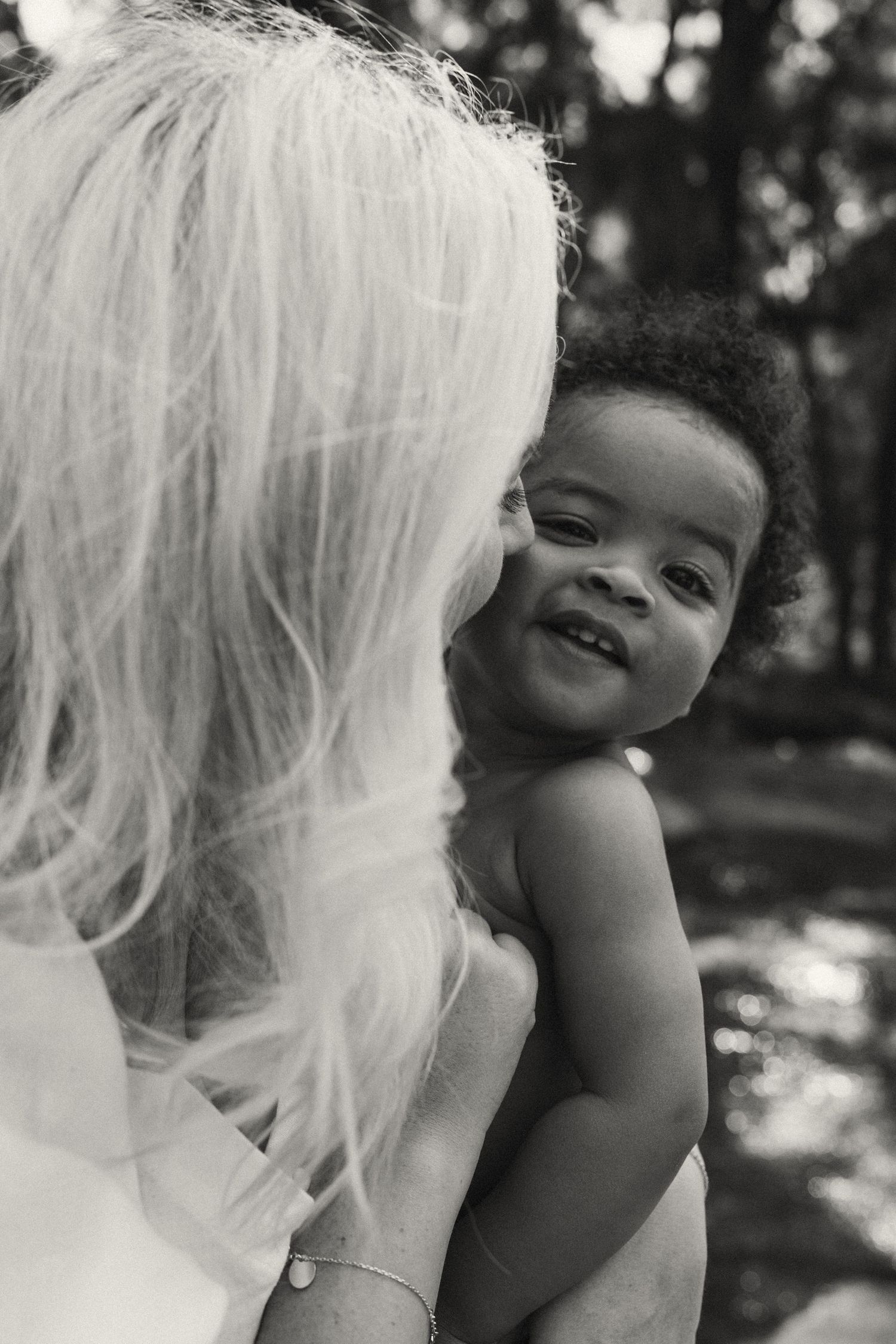 Black and white close-up captures of joyful bonding moments between parent and child.