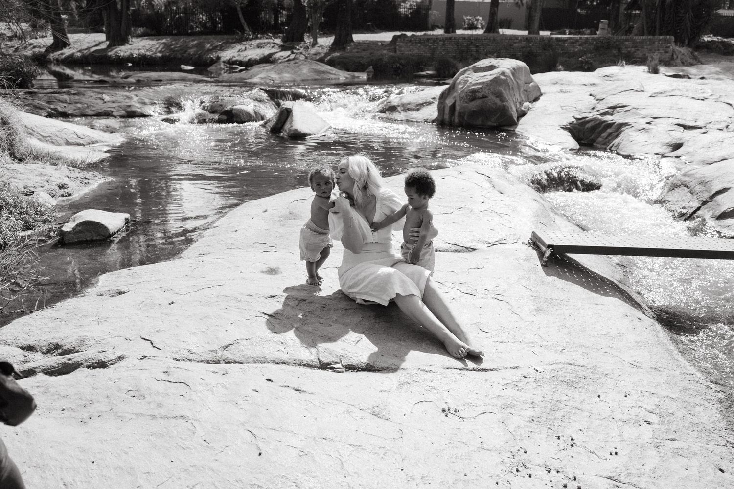 Black and white photograph of relaxed moments on natural stone formations.
