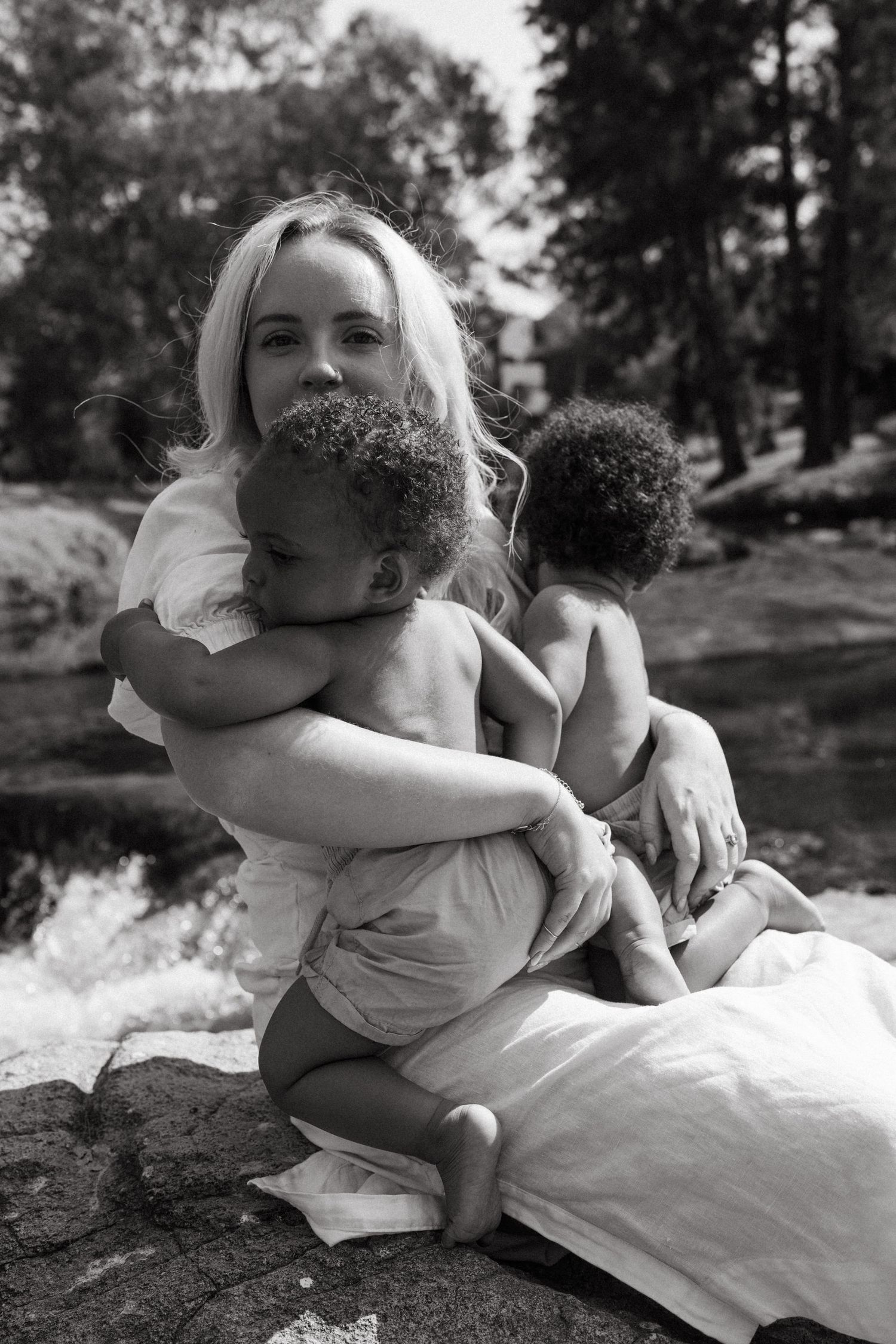 Intimate black and white portraits showing warm embraces outdoors.