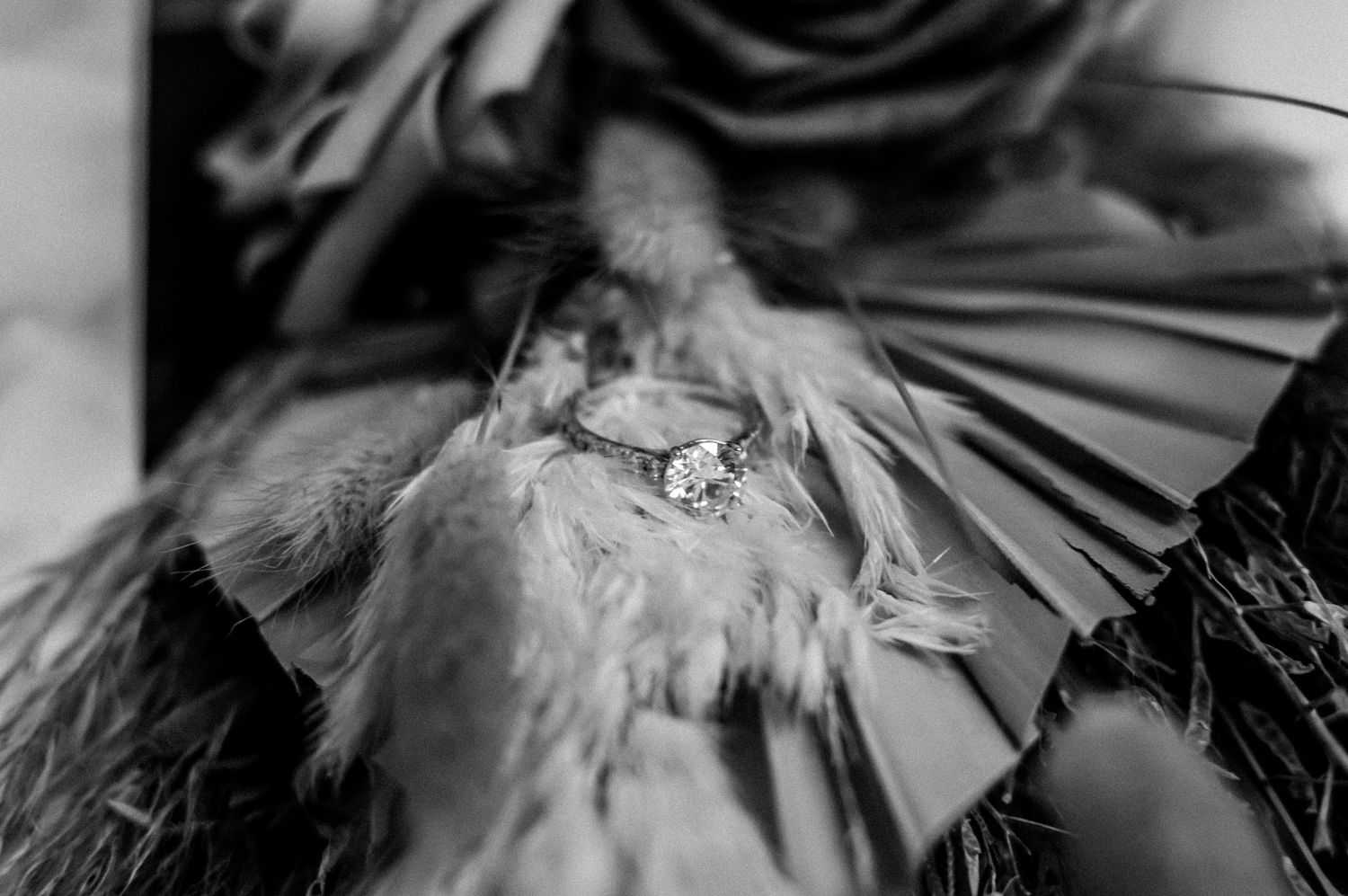 Artistic black and white close-up of wedding dress details and fabric.
