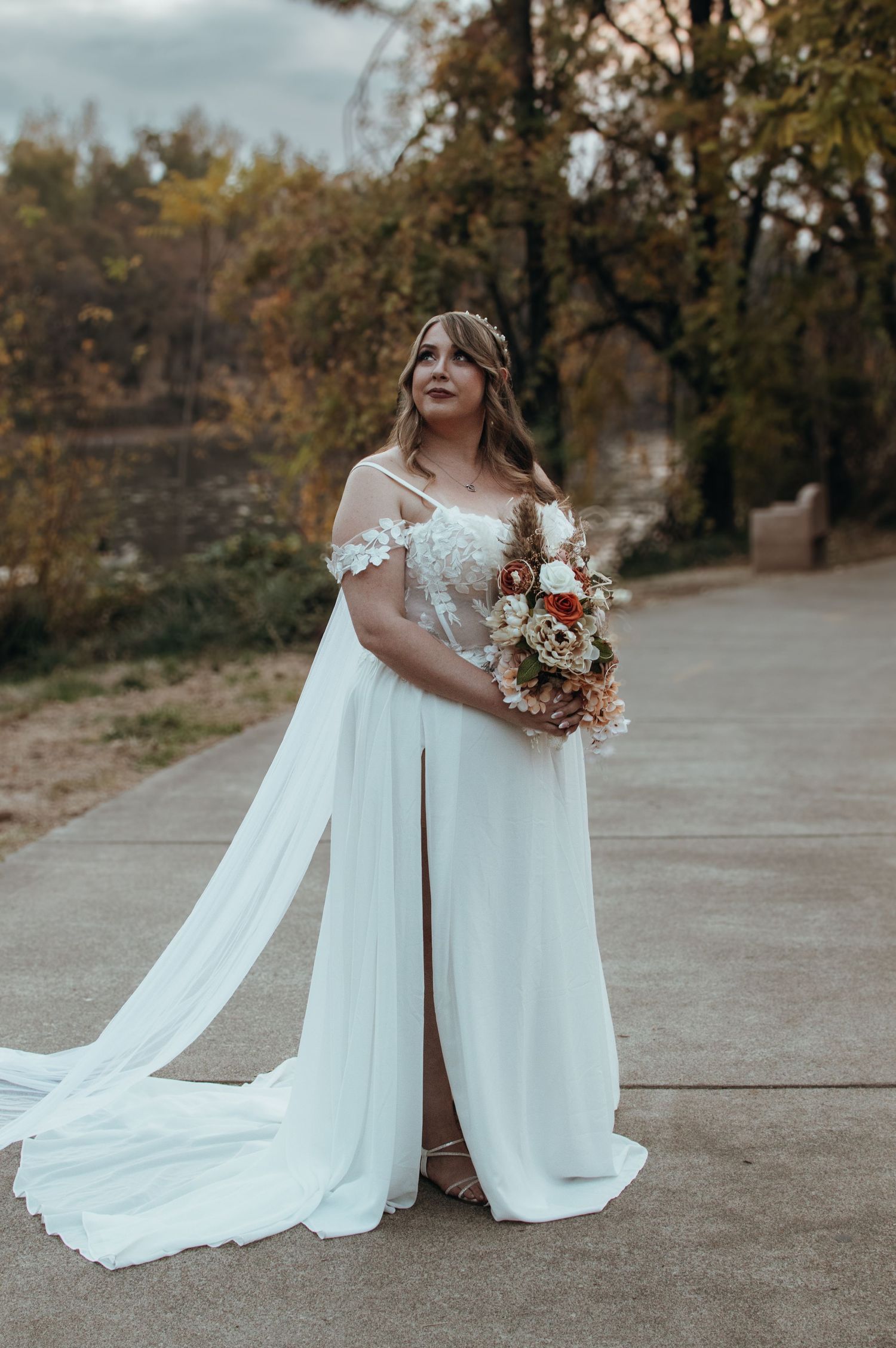 White wedding dresses flowing elegantly against an autumn outdoor backdrop.