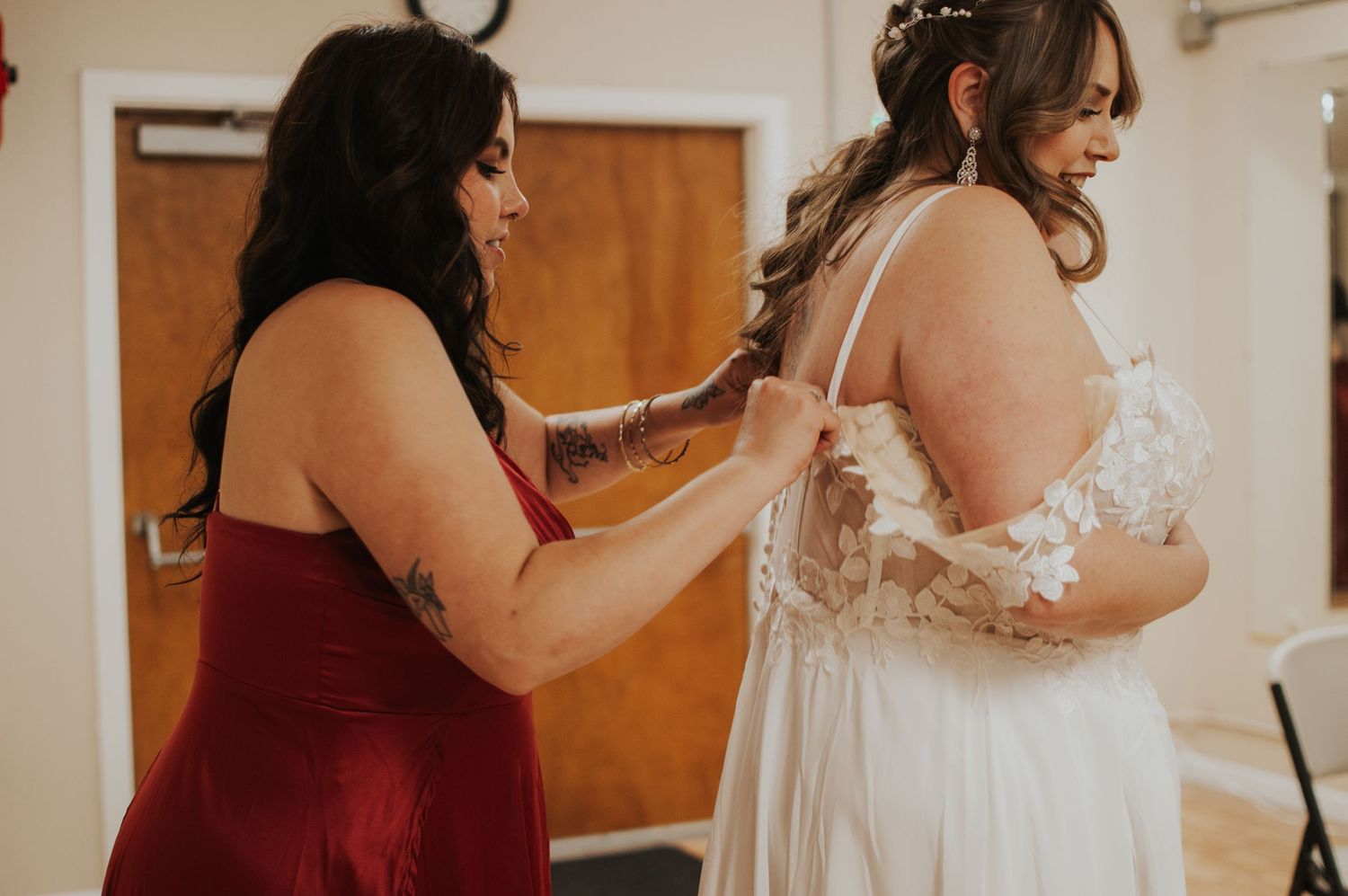 Wedding preparation scene with white dress and burgundy bridesmaid attire.
