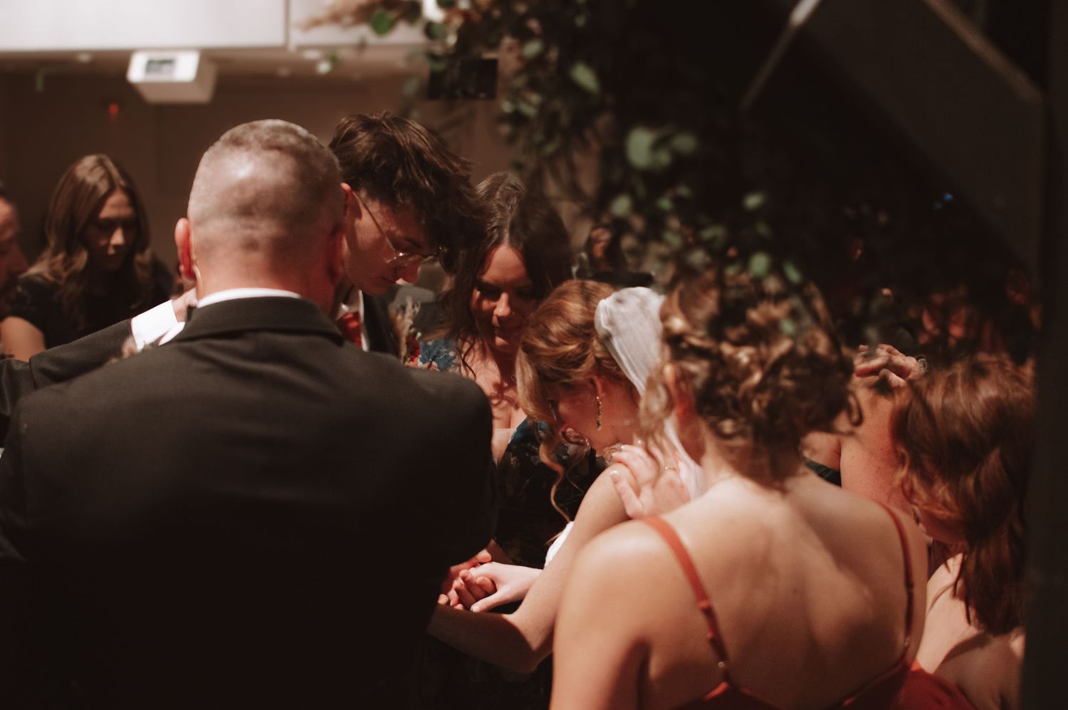 Candid celebration moment at an indoor wedding reception with crowd.