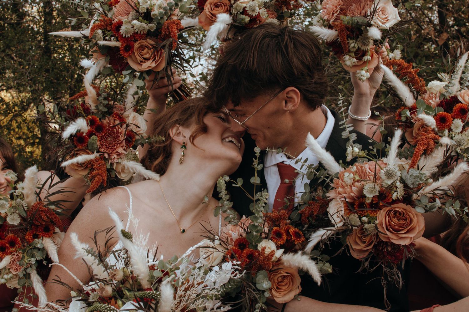 Beautiful floral arrangements featuring dusty rose and burgundy blooms create romantic wedding decor.