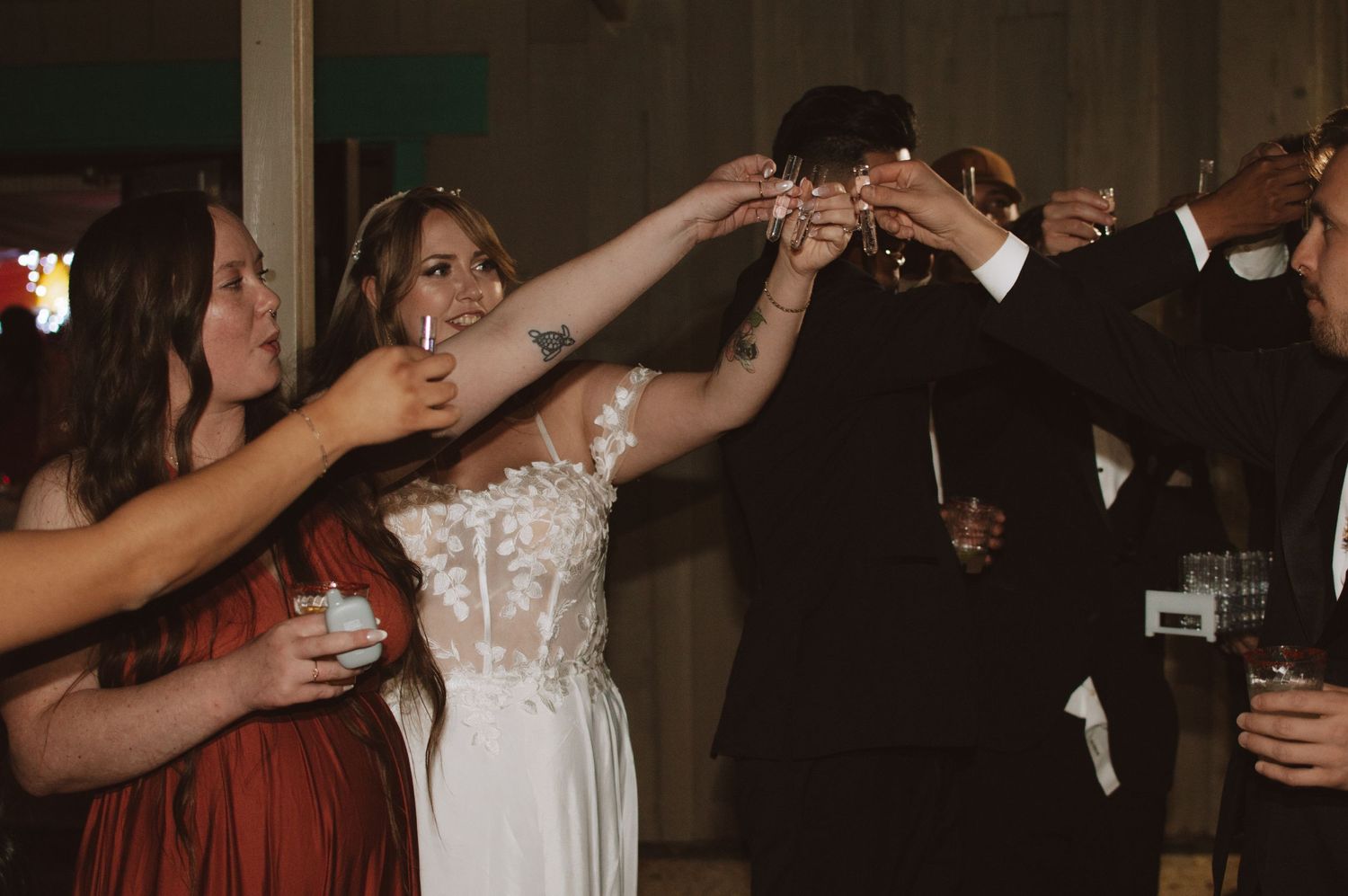 Wedding party raises glasses in a celebratory toast during the reception.