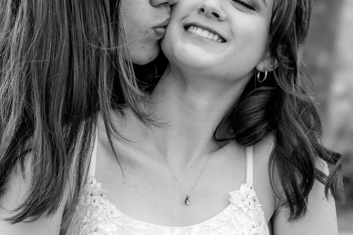 Black and white intimate moment captured with joyful expression.