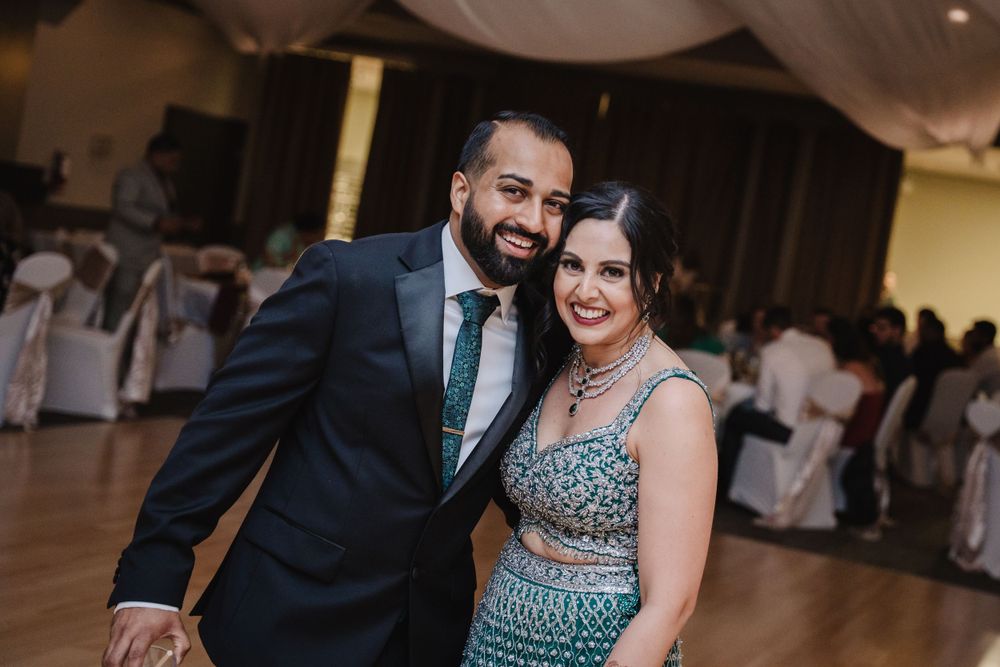 A couple shares a joyful moment on the dance floor at their wedding reception.