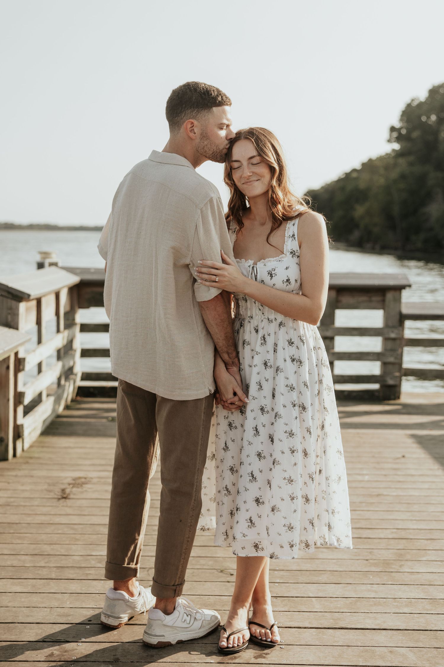 Summer romance captured on wooden pier by the waterfront.