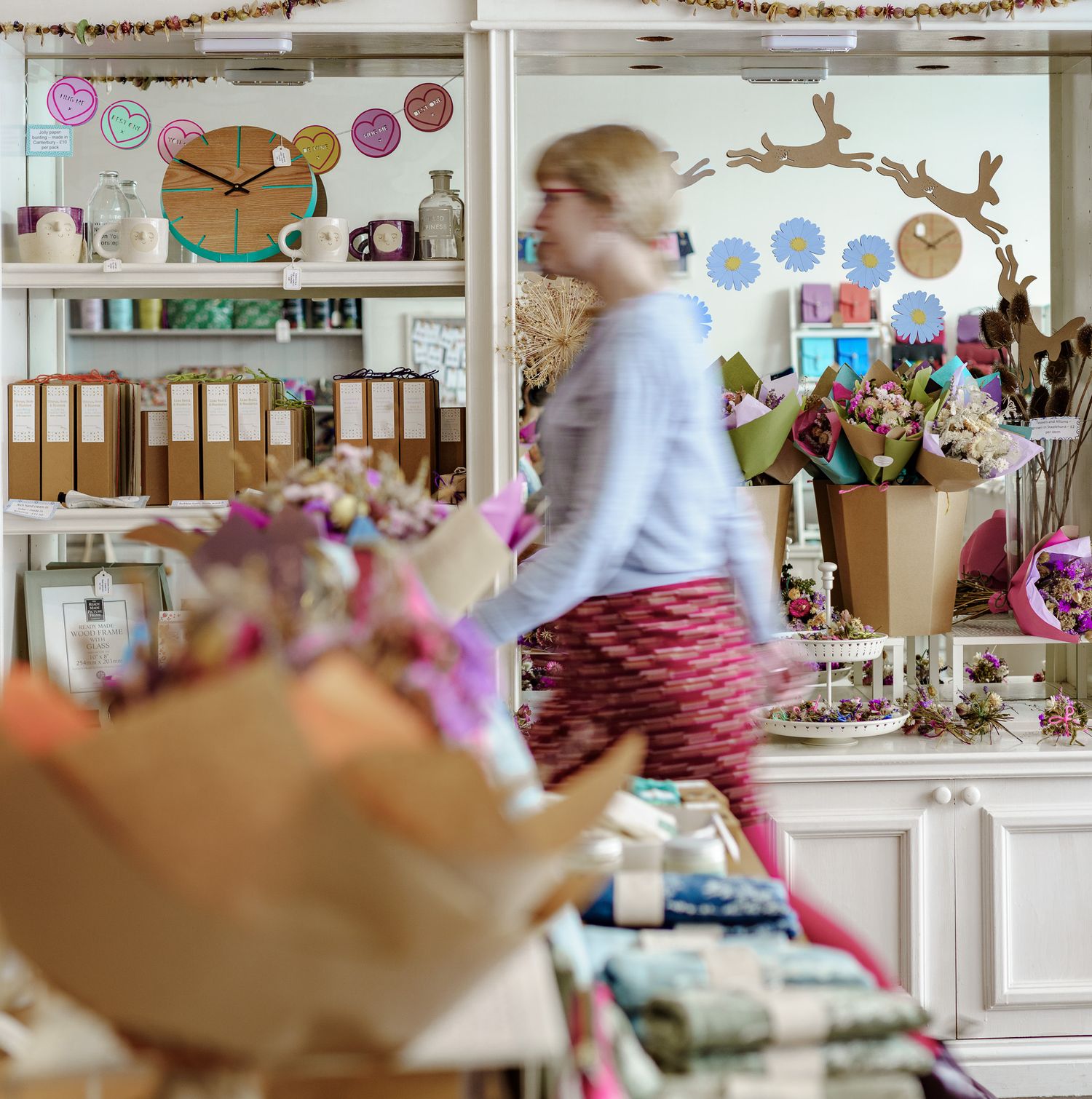 gift shop owner in long exposure shot through shop for creative social media content photography