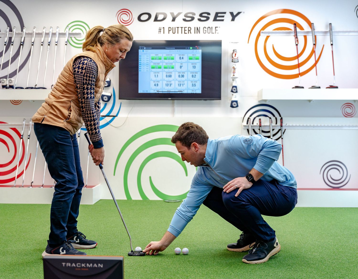golf pro giving person golf club fitting for website photography