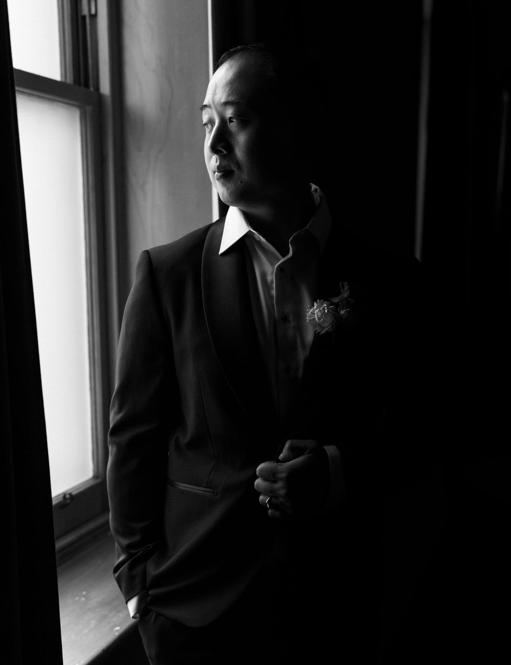 A dramatic black and white portrait series showing a person gazing pensively through a window in moody lighting.