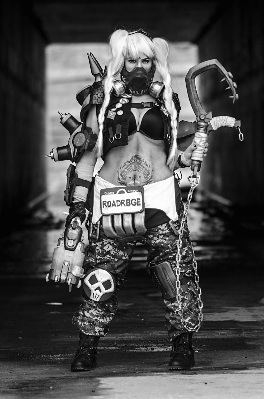 Post-apocalyptic cosplay with white pigtails, chains, and punk-style armor.