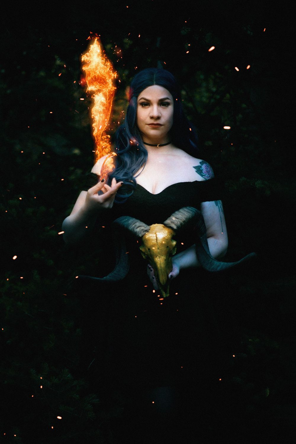 Dark fantasy cosplay with mystical fire effects and medieval-style costume.