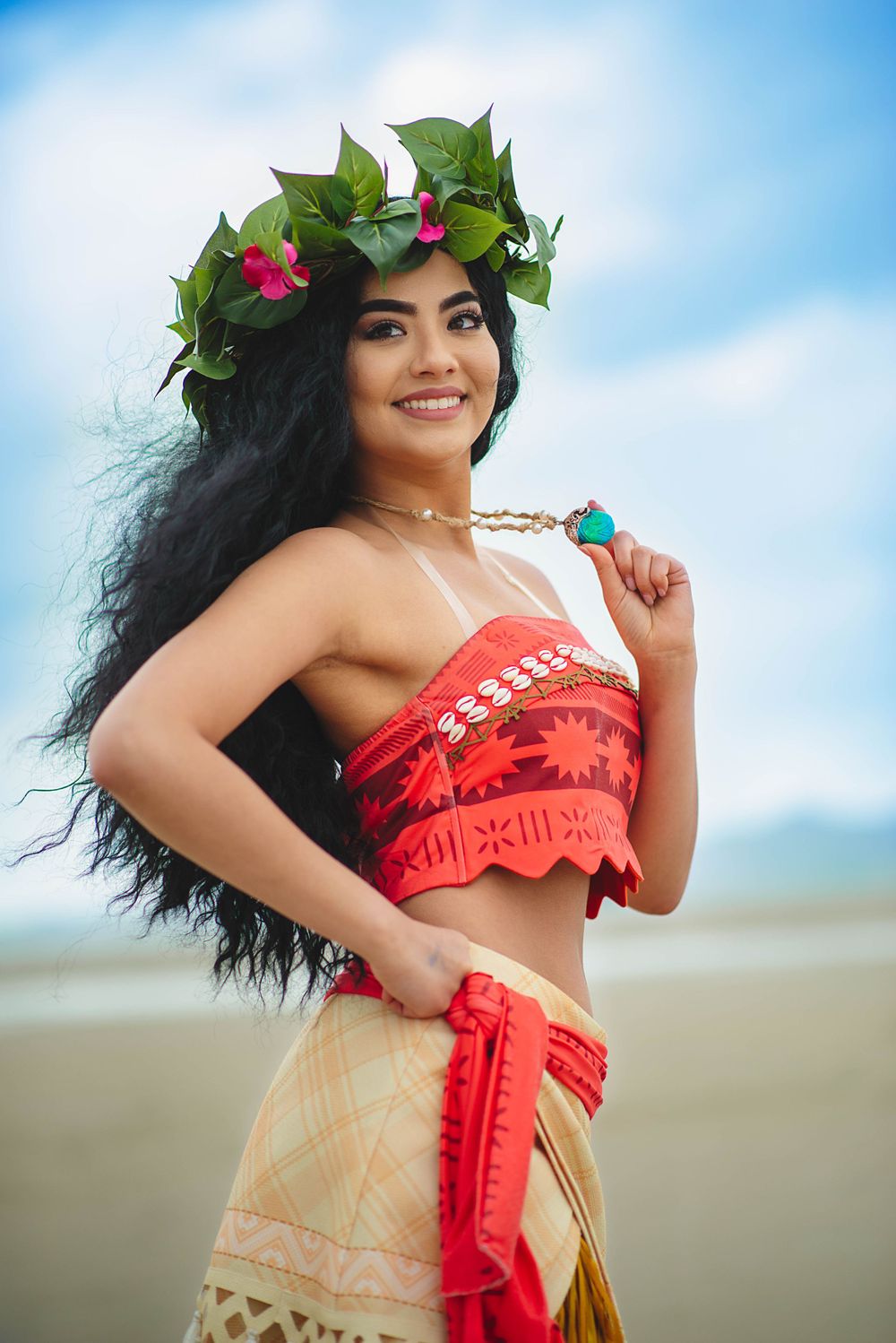 Polynesian-inspired beach cosplay with flower crown and traditional outfit.