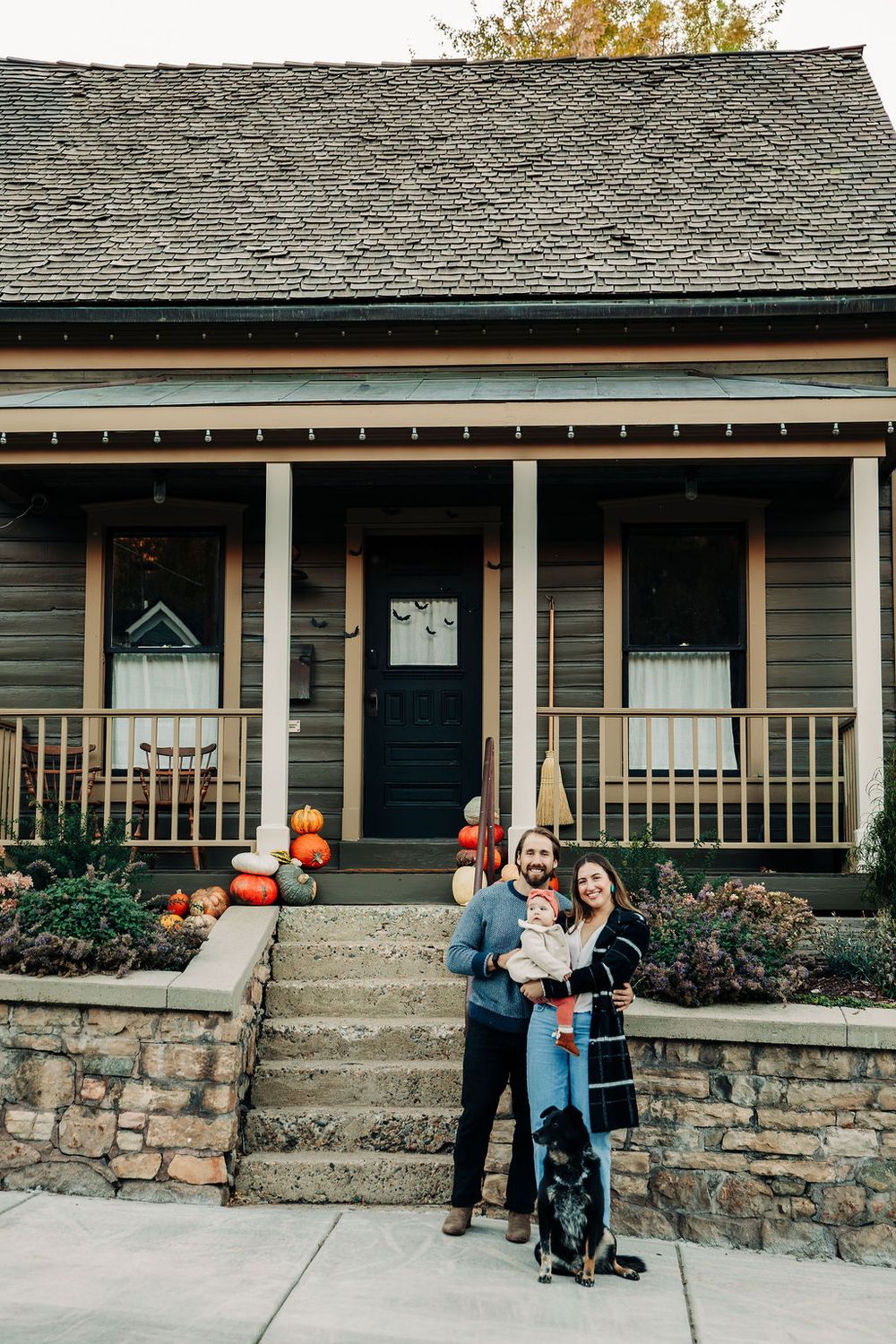 A sequence of photos showing a family outside their stone-foundation house with autumn pumpkin decorations on the porch.