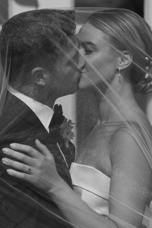 Black and white romantic wedding photo sequence showing tender kisses through a veil.