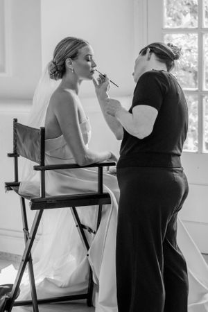 Black and white photo series showing a couple sharing intimate moments on director's chairs.