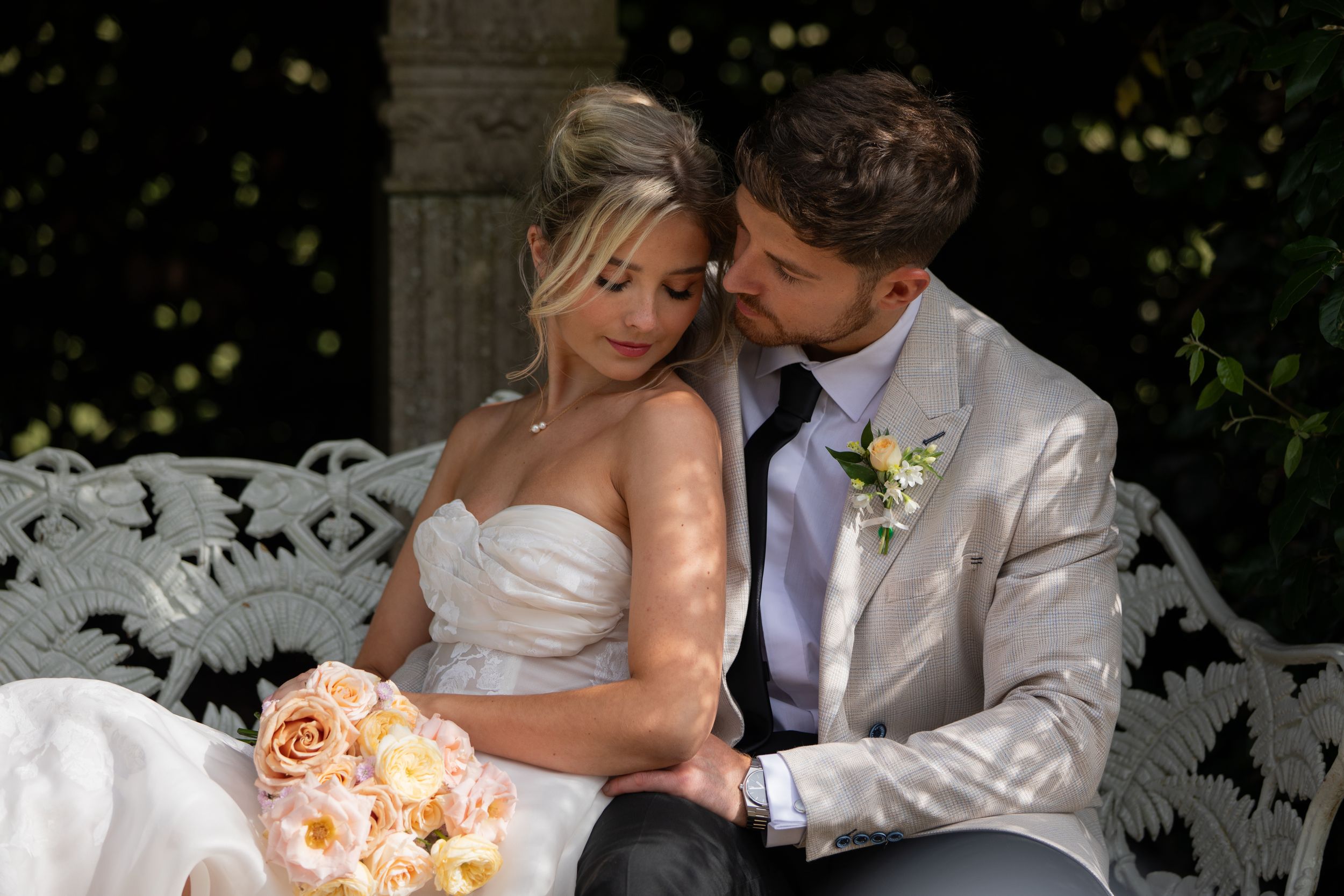 Romantic evening portraits of newlyweds sharing intimate moments in a garden setting.