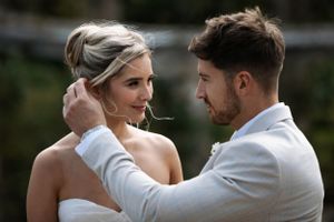 Romantic outdoor wedding portraits showing tender moments between newlyweds.