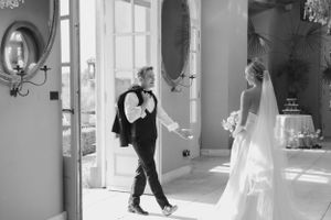 Black and white wedding photos capturing romantic moments in an elegant interior.